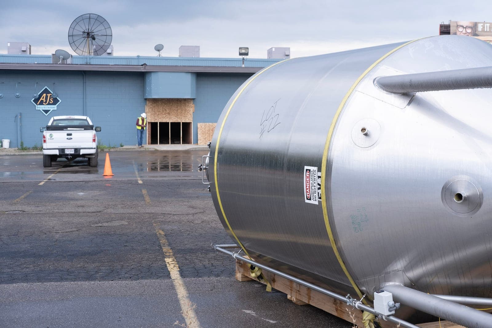 A new stainless fermenter on a pallet in the Brentwood parking lot