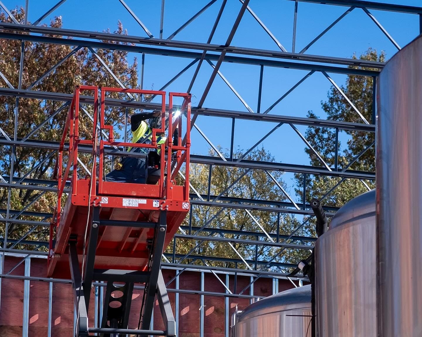 A crew on a lift installing the brewery roof