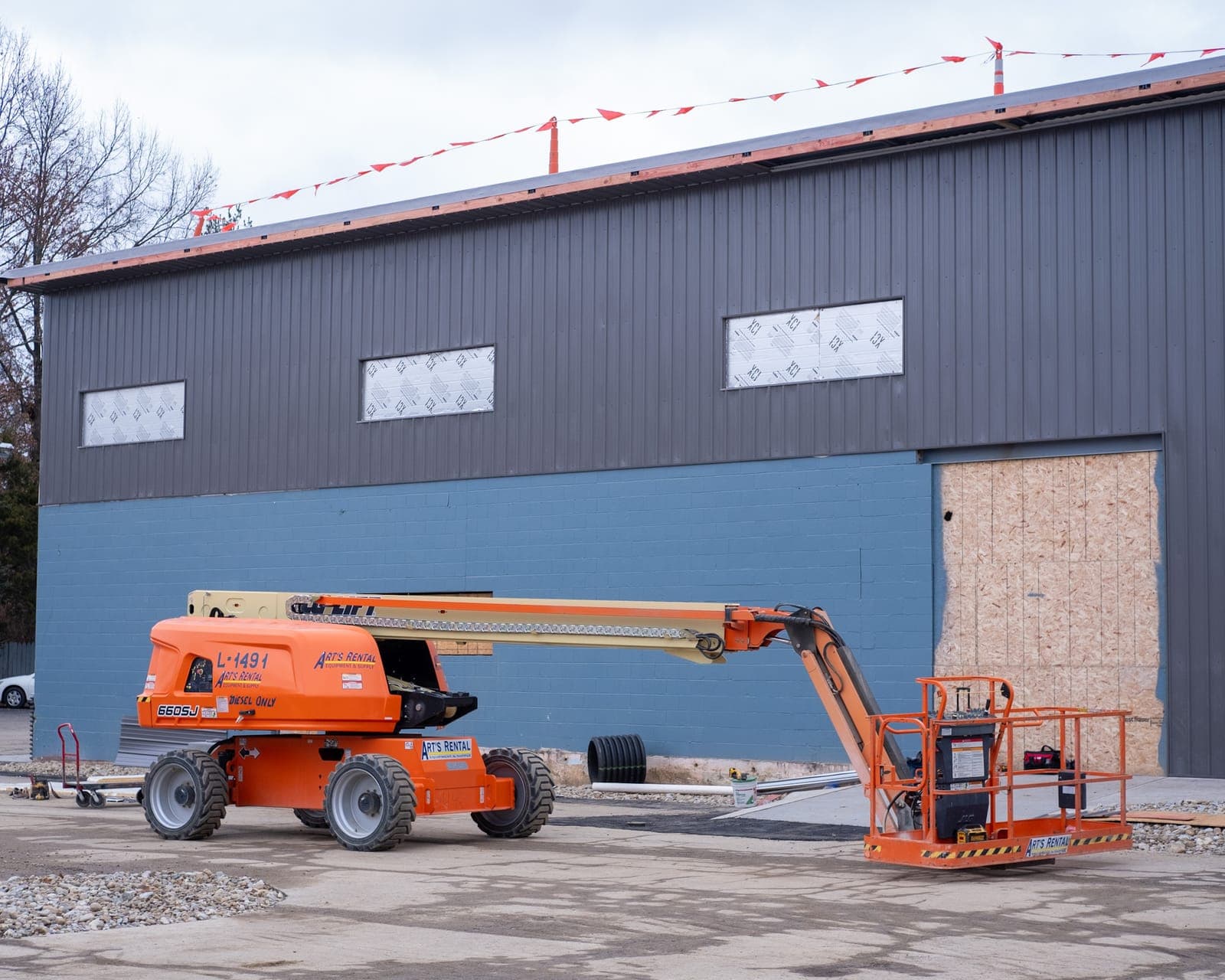 A boom lift outside the newly painted building