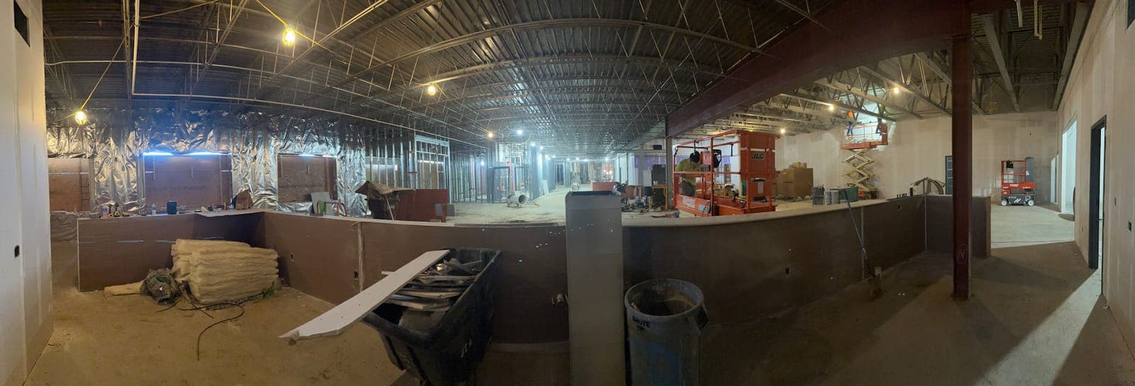 A wide view of the interior with the bar area roughed in