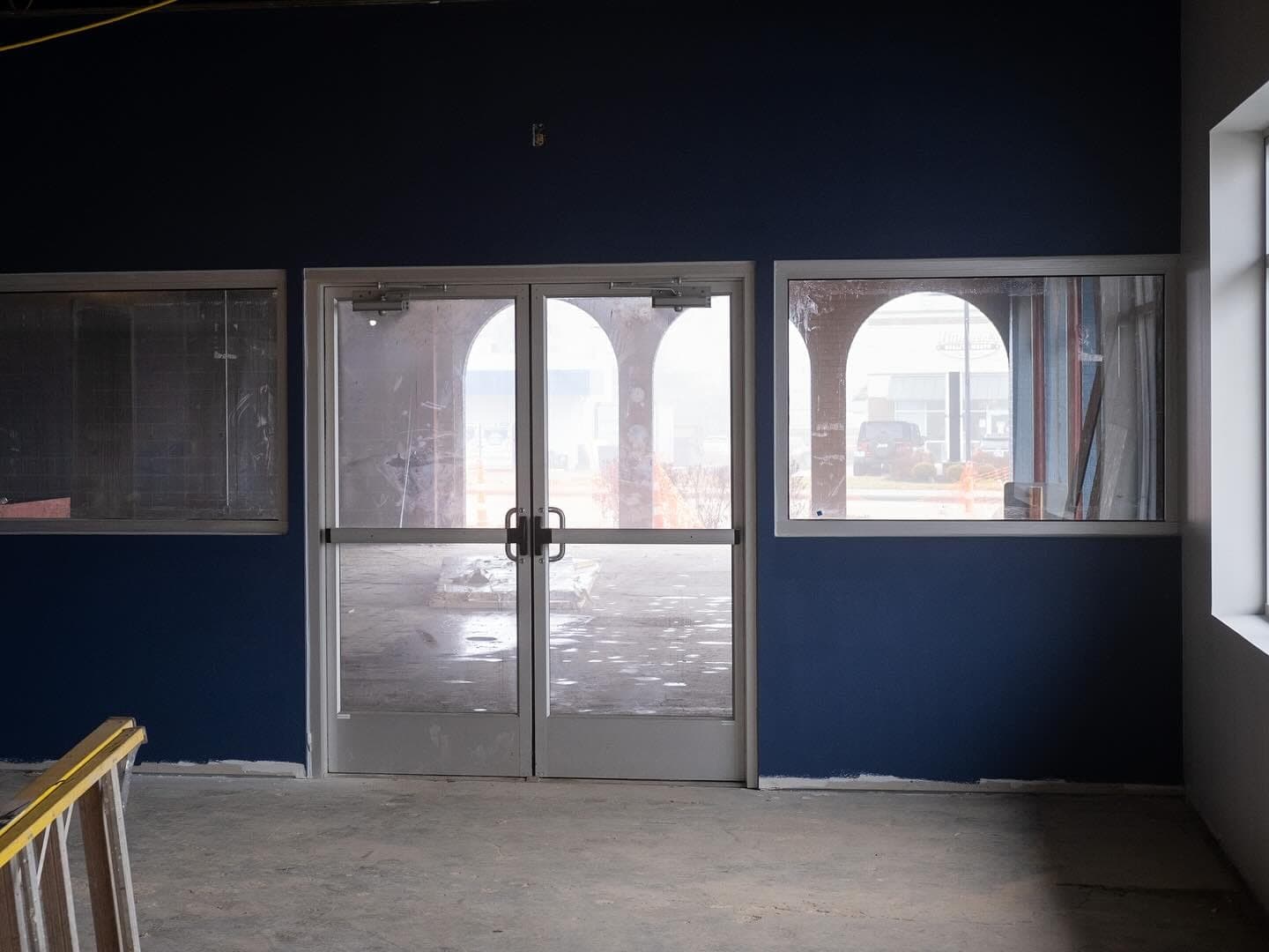 The arched front doors, painted and ready