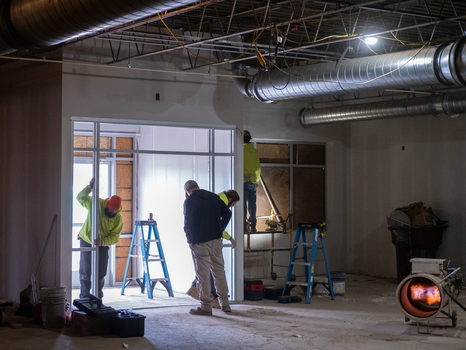 Crew members working at the new entry doors