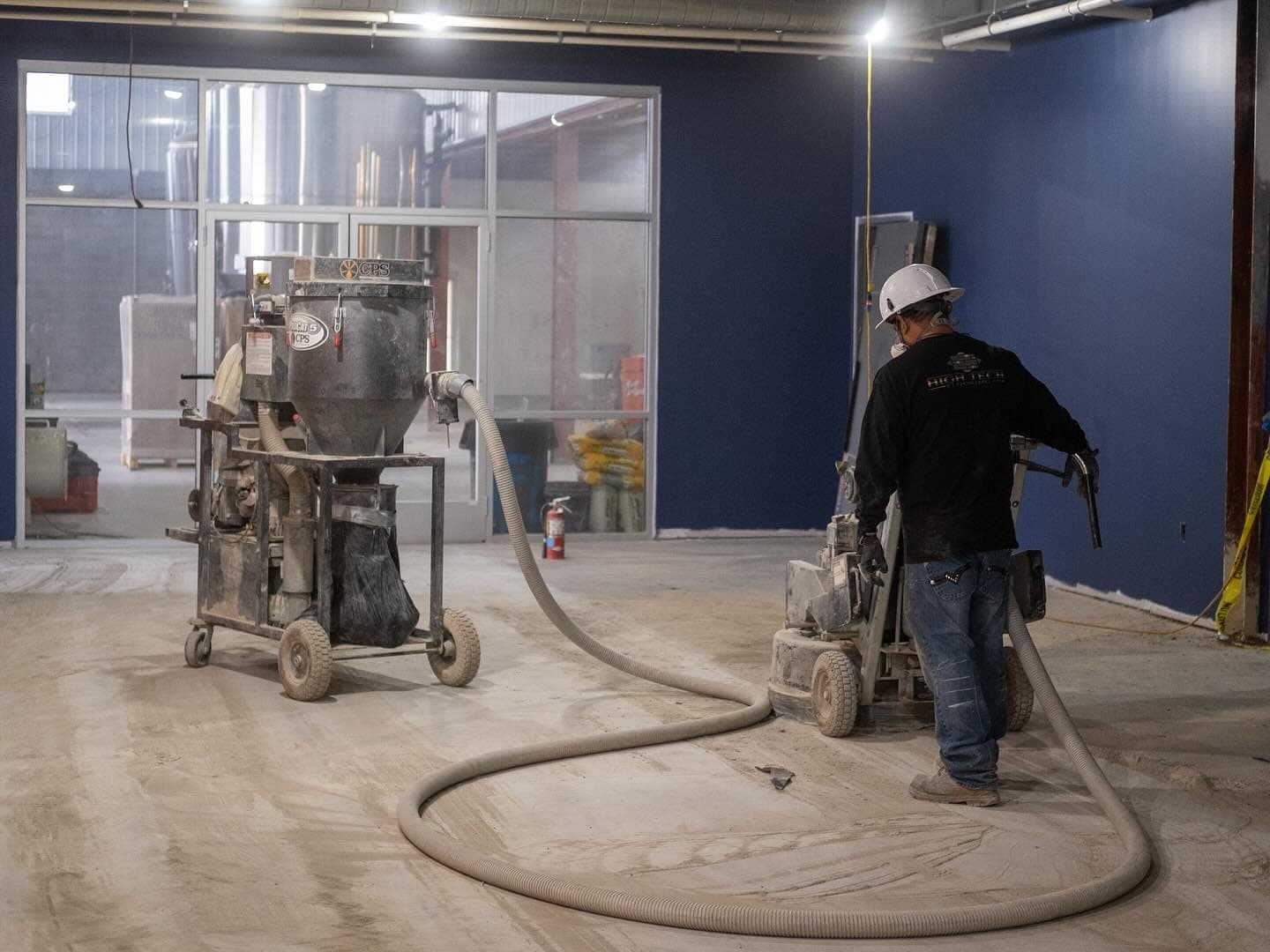 A worker finishing the concrete floors
