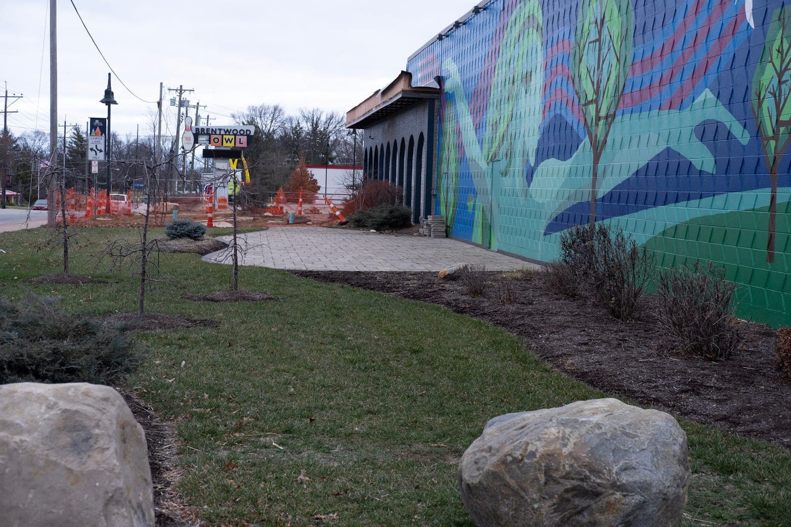 The mural wall with new landscaping, boulders and a walkway
