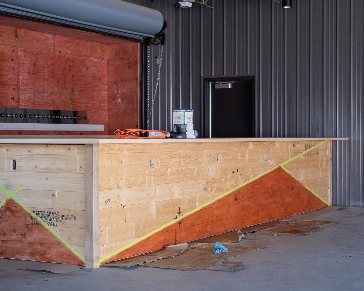The patio bar front, built from the wood crate that delivered the brewery's centrifuge