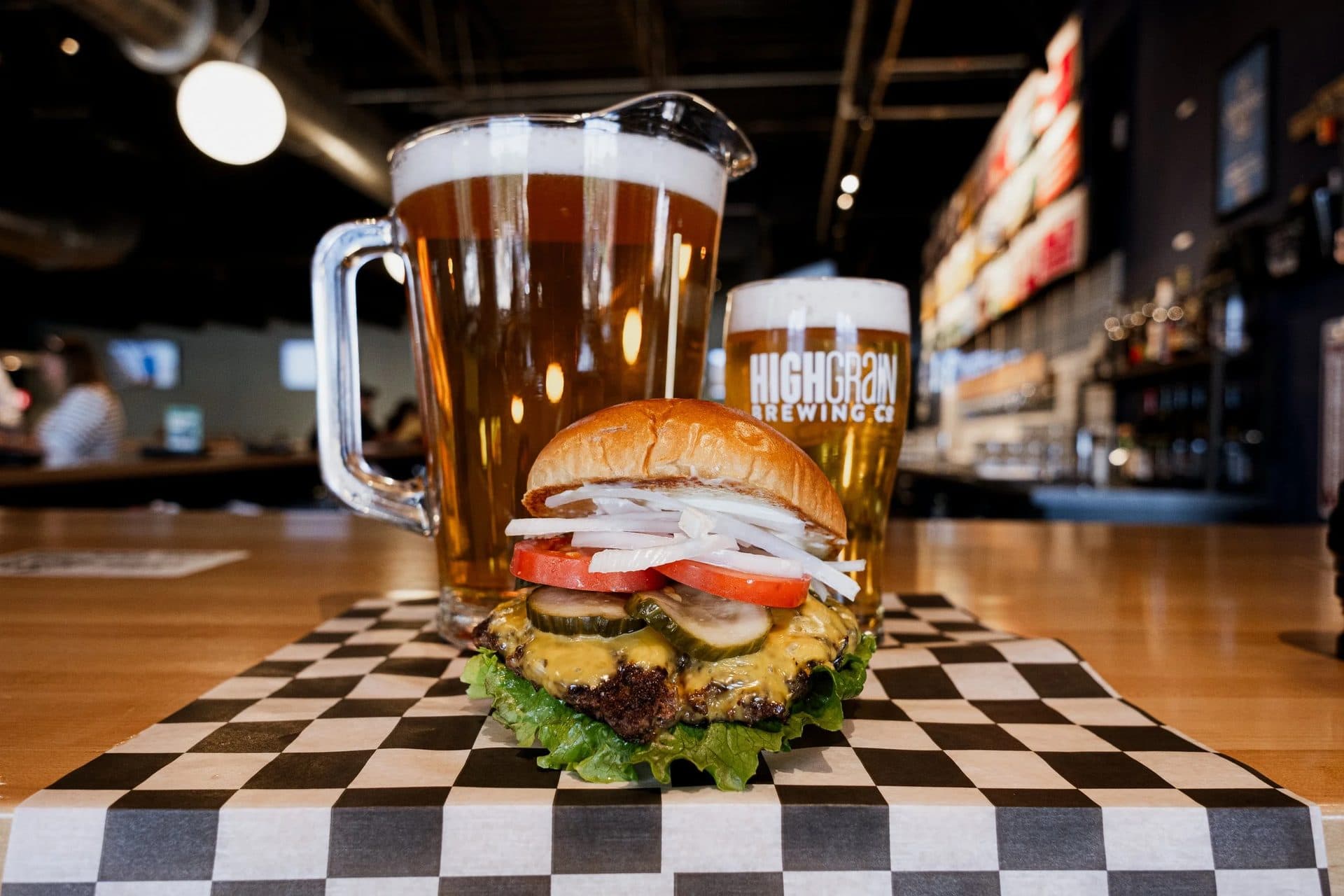 HighGrain Brewing beer glass and burger on checkered table brentwood brewpub