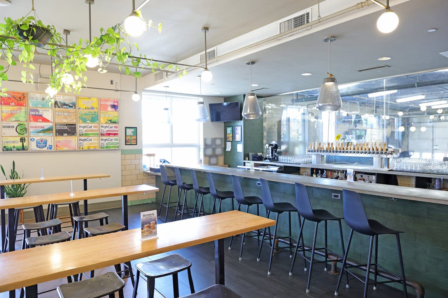 The Silverton bar, with the beer boards on the wall and the brewery behind glass
