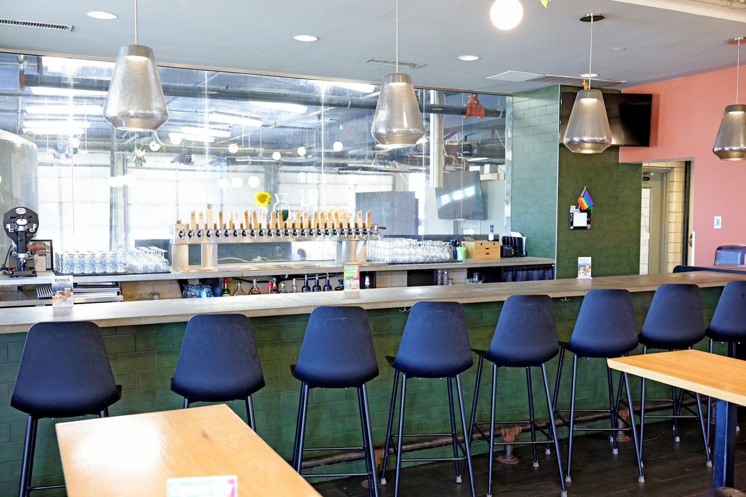 The Silverton bar's row of taps with a view into the brewery