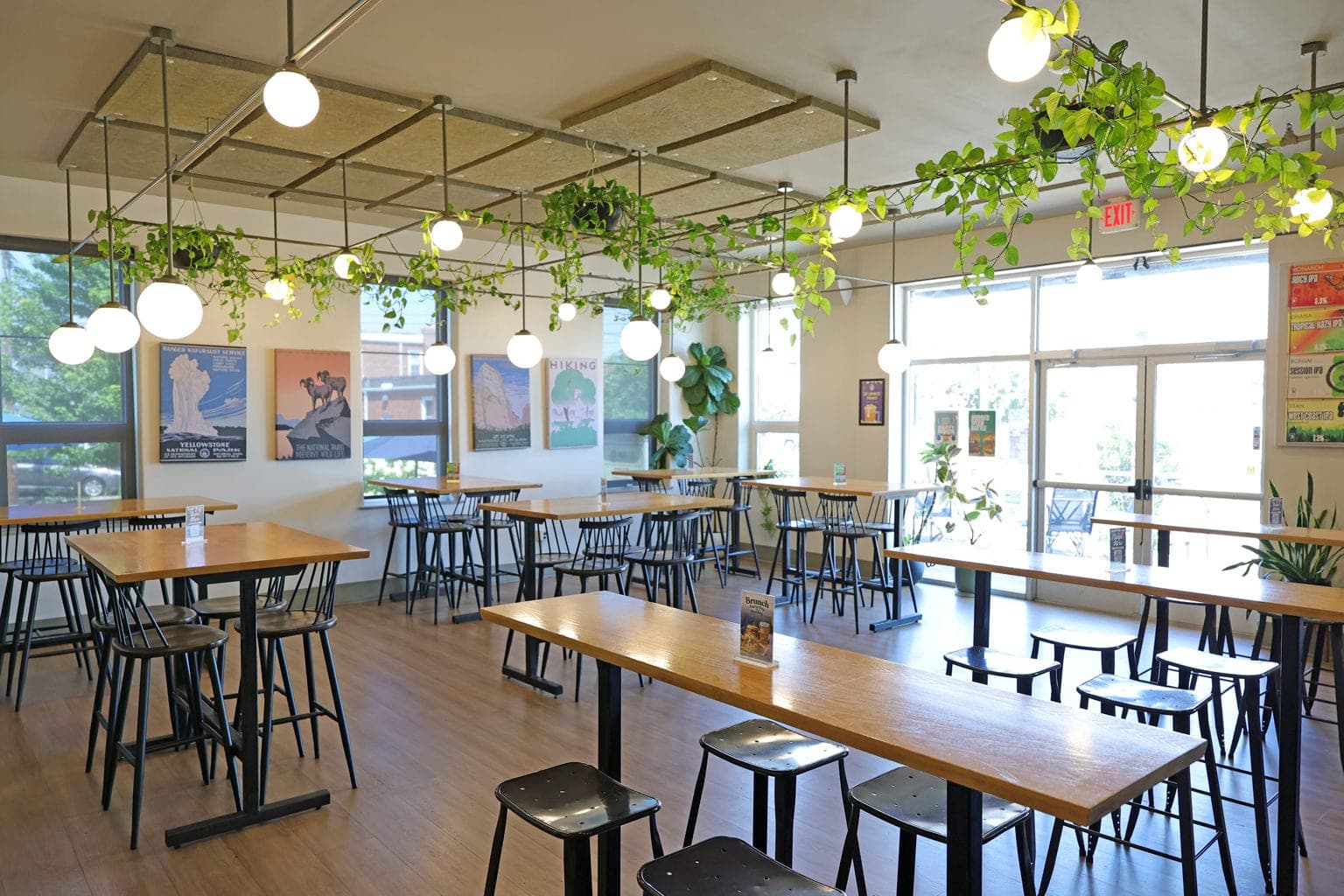 The Silverton dining room with hanging plants, globe lights and national park posters