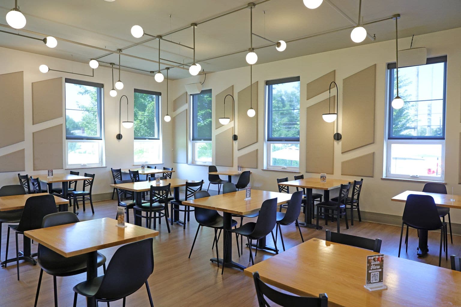 The Silverton dining room with tall windows and acoustic wall panels