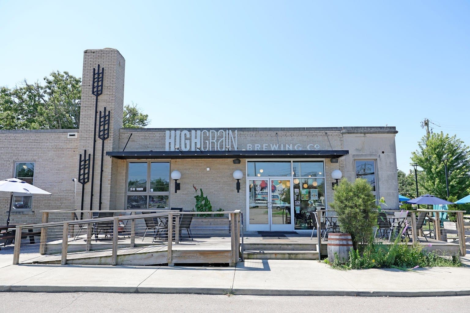 The HighGrain Silverton taproom's front entrance, with the HighGrain Brewing Co. sign, the wheat-stalk tower and the front deck