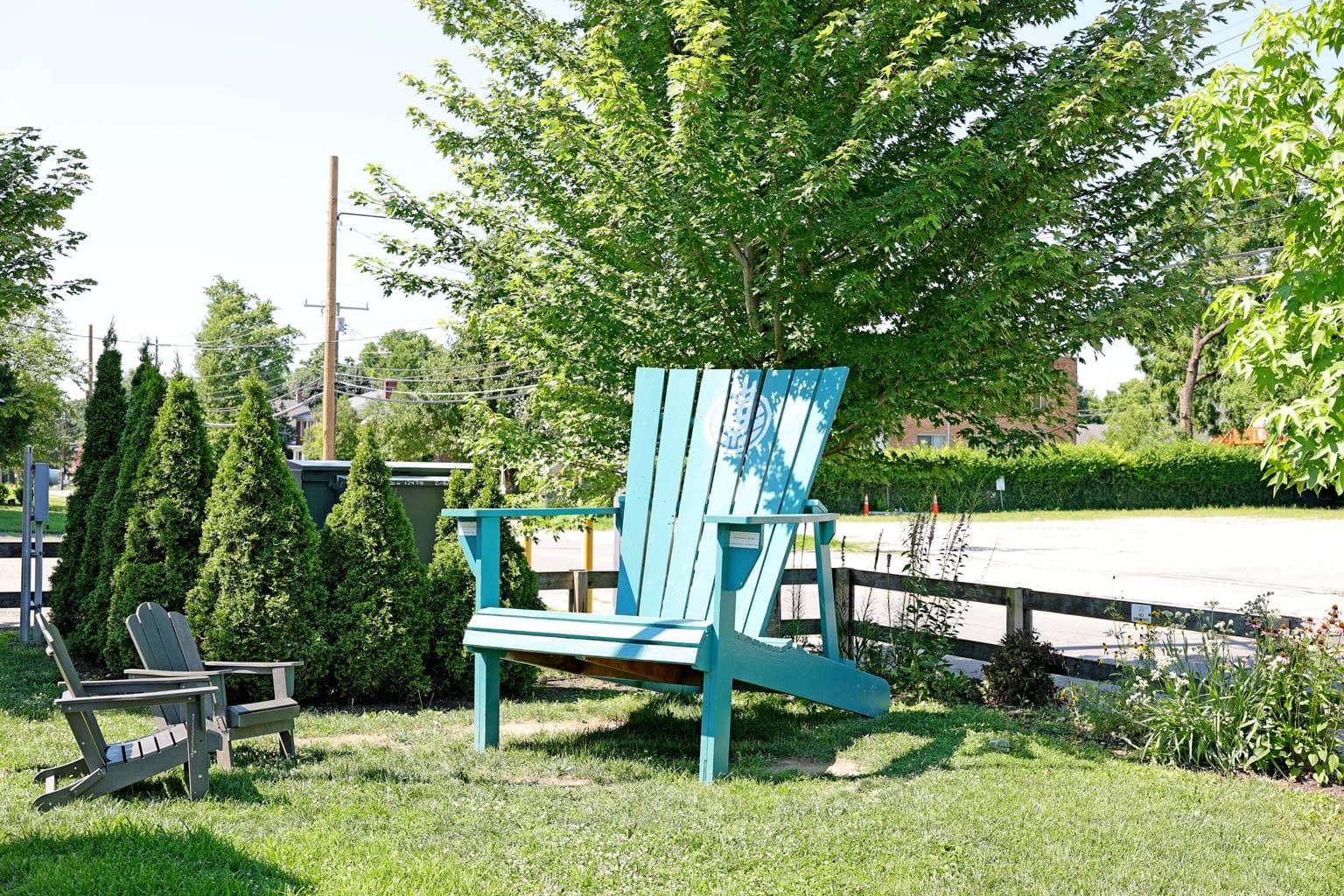 The giant teal Adirondack chair with the HighGrain logo on the Silverton lawn